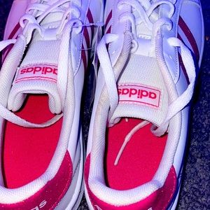 Pink sparkly adidas shoes.